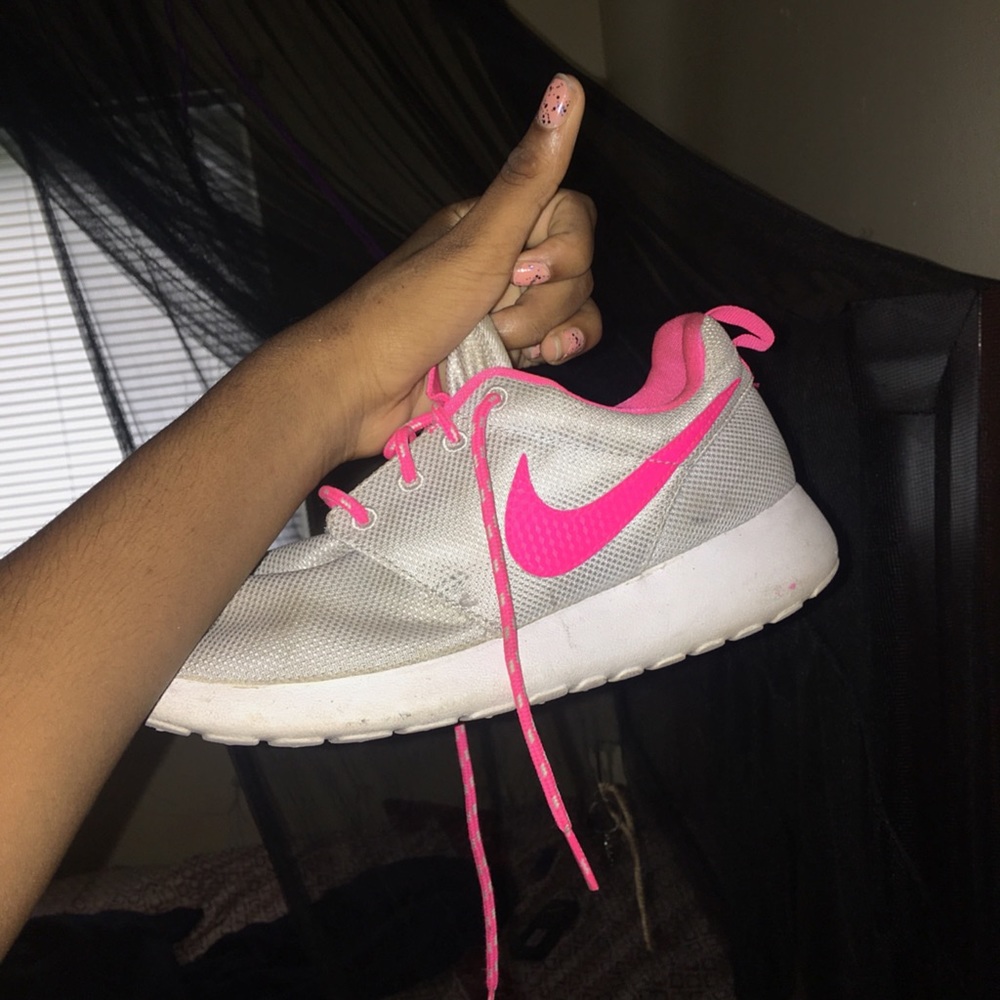 Silver and pink roshe runs